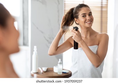 Woman Styling Hair Spraying Hairspray For Repair In Modern Bathroom