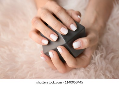Woman and stylish color nails holding decoration  closeup