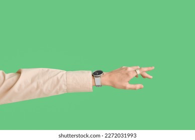 Woman with stylish wristwatch on green background - Shutterstock ID 2272031993