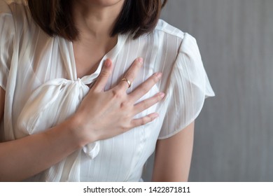 woman with sudden heart attack; sick woman suffering from acute heart attack, concept of emergency health care; asian young adult woman model - Shutterstock ID 1422871811