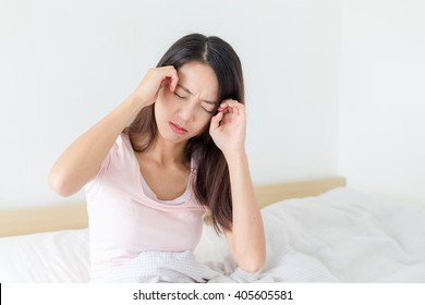 Woman Suffer From Headache And Resting On Bed