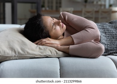 Woman Suffer From Restless Sleep, Having Insomnia Or Nightmares, Frowning Lying On Sofa With Closed Eyes Cant Fall Asleep. Sleeping Disorder, Life Troubles, Poor Insufficient Low-quality Sleep Concept