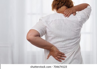 Woman Suffering From Back And Neck Pain. Chiropractic, Osteopathy, Physiotherapy. Alternative Medicine, Pain Relief Concept.