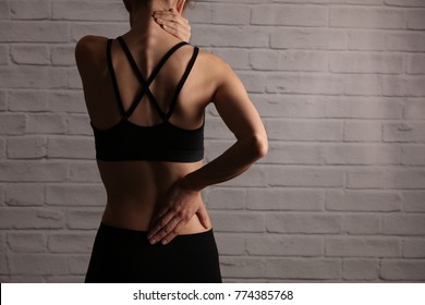 Woman Suffering From Back And Neck Pain. Incorrect Sitting Posture Problems, Muscle Spasm, Rheumatism. Pain Relief , Chiropractic Concept. Sport Exercising Injury