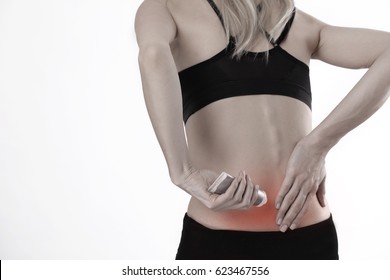 Woman Suffering From Back Pain Applying Pain Relief Cream . Sports Exercising Injury.