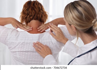 Woman Suffering From Back Pain During Medical Exam. Chiropractic, Osteopathy, Physiotherapy. Alternative Medicine, Pain Relief Concept.