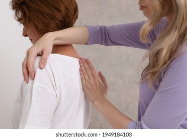 Woman Suffering From Back Pain Having Chiropractic Back Adjustment. Osteopathy, Alternative Medicine, Pain Relief Concept.