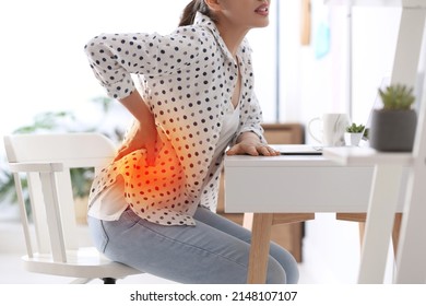 Woman suffering from back pain in office. Bad posture problem - Shutterstock ID 2148107107