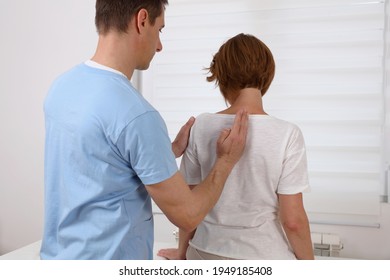 Woman Suffering From Back Painhaving Chiropractic Back Adjustment. Osteopathy, Alternative Medicine, Pain Relief Concept.