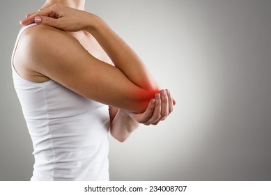Woman suffering from chronic joint rheumatism. Elbow pain and treatment concept. 