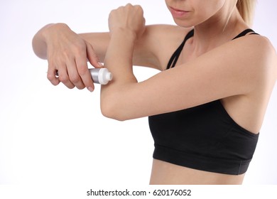 Woman Suffering From Elbow Ban Applying Pain Relief Cream