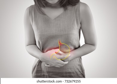 Woman suffering from gastroesophageal reflux disease or Acid reflux standing against gray background, Female Anatomy Concept - Shutterstock ID 732679255