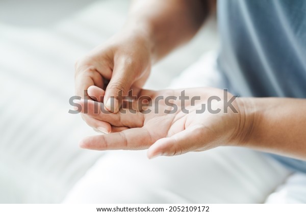 Woman suffering from hand and finger joint\
pain​.​ Causes of rheumatoid arthritis, carpal tunnel syndrome,\
gout. Health care and medical\
concept.
