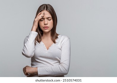 Woman suffering from headache desperate, stressed because pain and migraine. Woman touching her temples feeling stress, on gray background. Girl suffering from headache. Cold symptoms. - Powered by Shutterstock