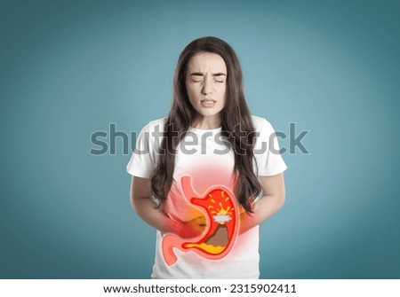 Woman suffering from heartburn on turquoise background. Stomach with erupting volcano symbolizing acid indigestion, illustration