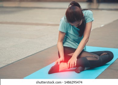 Woman Suffering Or Injury Leg After Do Yoga. Mature Female Or Senior Has Pain In His Foot Or Shin While Exercise Or Warm Up. Sport Girl Hurting Holding Painful Sprained Ankle In Pain. Safety, Health