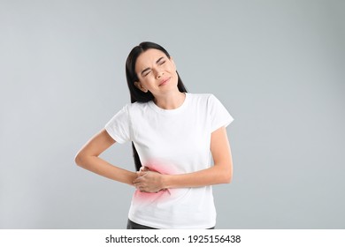 Woman Suffering From Liver Pain On Grey Background