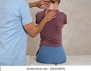 Woman Suffering From Neck And Back Pain During Medical Exam. Chiropractic, Osteopathy, Physiotherapy. Bad Posture Correction