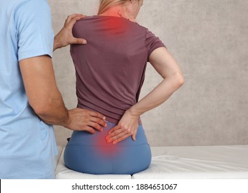 Woman Suffering From Neck And Low Back Pain During Medical Exam. Chiropractic, , Physiotherapy. Posture Correction