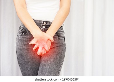woman suffering from pain, itchy crotch hand holding her burning  vaginal caused by bladder infections or cystitis 