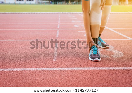 Woman suffering from pain in legs with knee injury after sport exercise running jogging and workout outdoor