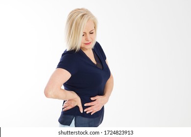 A Woman Suffering From Severe Pain In Her Tummy. Isolated On White. Mature Woman Standing And Having Stomach Ache, Sick Woman With Menstruation Pain, Ill Woman Suffers From Cramp, Stomach Ache, Belly 