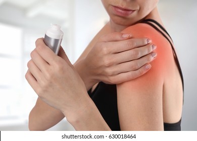 Woman Suffering From Shoulder Back Pain Applying Pain Relief Cream . Sports Exercising Injury.