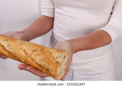 Woman Suffering From Wheat And Gluten Allergy Holding Bread. Food Allergy Symptoms Rush, Itching, Skin Redness.