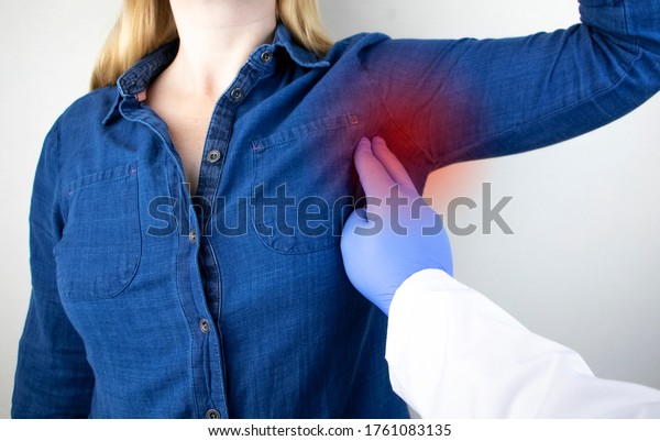 A woman suffers from pain in the\
armpit. Sweating, unpleasant odor, redness, tooth and inflammation\
in the armpit. Breast Cancer Prevention\
Concept