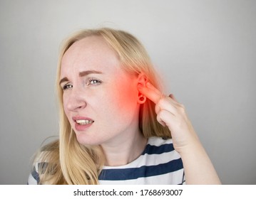 A woman suffers from pain in the ear. The auditory meatus hurts due to otitis media, cerumen plug, ear boil, or trigeminal neuralgia