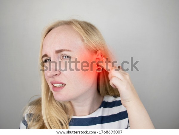 A woman suffers from pain in the ear. The\
auditory meatus hurts due to otitis media, cerumen plug, ear boil,\
or trigeminal neuralgia