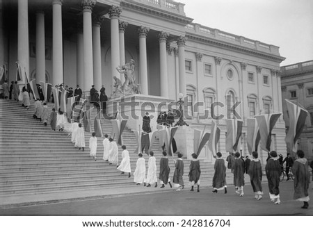 Woman Suffrage demonstration with banners at the U.S. Capitol in 1917. View of Procession ascending Capitol steps.