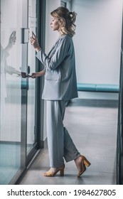 Woman In Suit With High Heels In Office Corridor