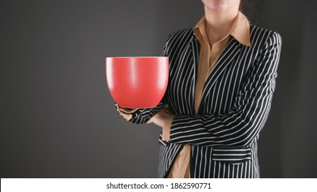 Woman in a suit with a red mug - Powered by Shutterstock