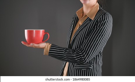 Woman in a suit with a red mug - Powered by Shutterstock