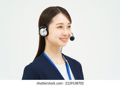 A Woman In A Suit Wearing A Headset