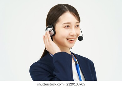 A Woman In A Suit Wearing A Headset