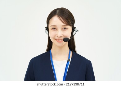 A Woman In A Suit Wearing A Headset