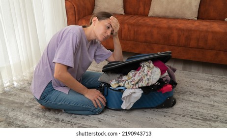 Woman With A Suitcase That Does Not Fit Clothes, Women's Wardrobe. High Quality Photo