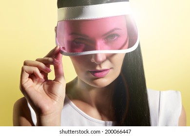 Woman In A Sun Visor On A Sunny Yellow Background