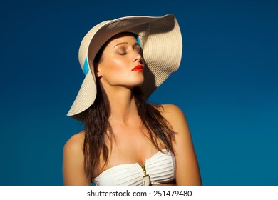 Woman In The Sun Wearing A Hat And Bikini. 