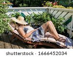 woman sunbathes on a balcony