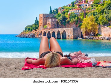 Woman Sunbathing At The Alanya Beach - Alanya, Turkey