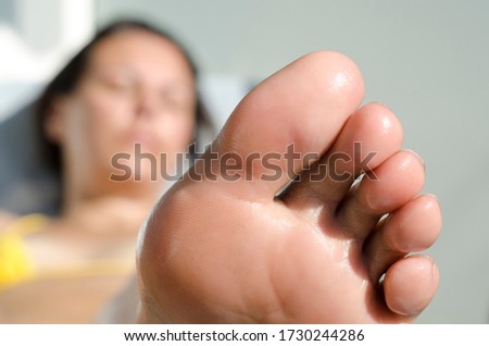 Woman Sunbathing and Close Up on Her Foot.