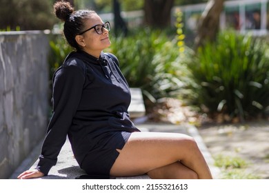 Woman Sunbathing On A Bench In Chapultepec Park, Mexico City, Mexico