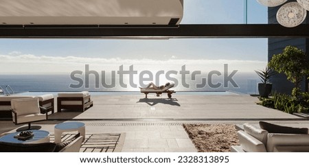 Woman sunbathing on lounge chair at poolside overlooking ocean