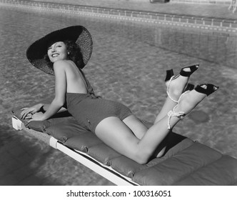Woman sunbathing at pool