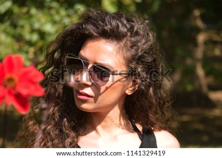 Similar – Woman with sunglasses looking at camera over garden fence