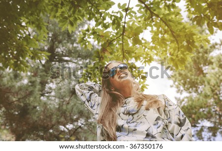 Similar – Woman with sunglasses touching over nature background