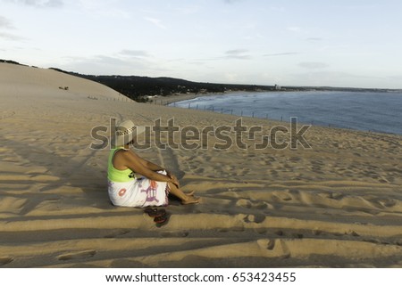 Woman at sunrise in Genipabu Dunes and Beach